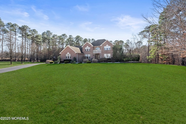 georgian-style home with a front lawn