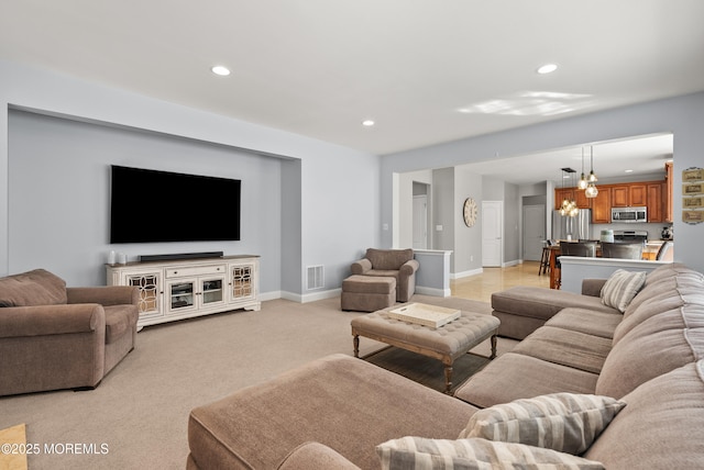 living room featuring light carpet, visible vents, baseboards, and recessed lighting