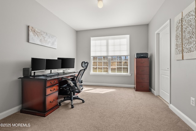 carpeted office featuring baseboards