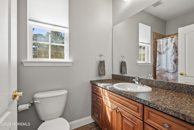 bathroom featuring visible vents, toilet, a shower with curtain, tile patterned flooring, and vanity