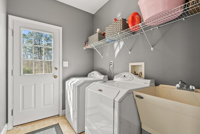 laundry room featuring laundry area, light tile patterned flooring, a sink, and washer and dryer