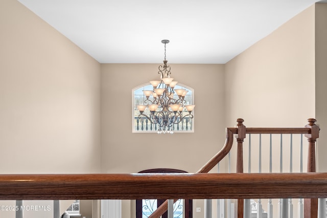 stairway featuring a chandelier