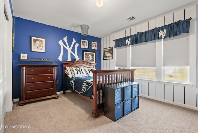 carpeted bedroom featuring visible vents