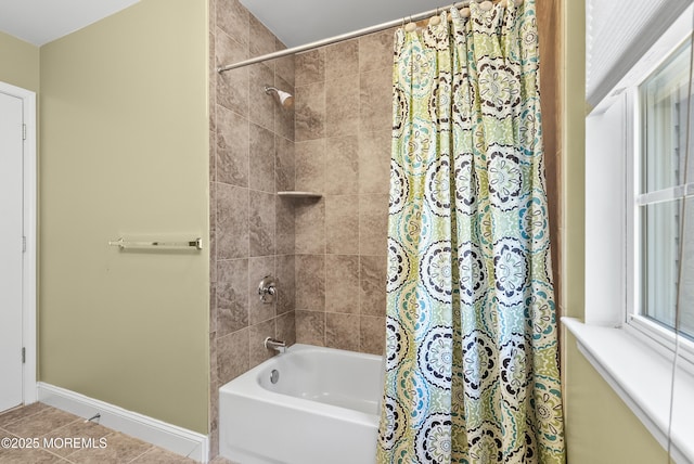 bathroom featuring shower / bath combo, tile patterned flooring, and baseboards