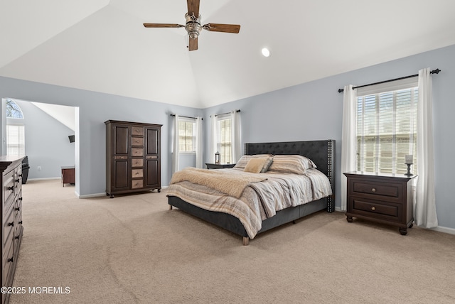 bedroom with light colored carpet, baseboards, and multiple windows