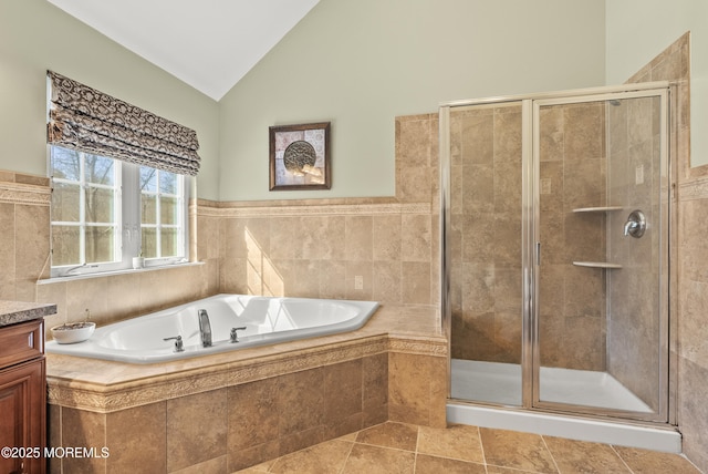 full bath featuring a garden tub, a shower stall, vaulted ceiling, and vanity