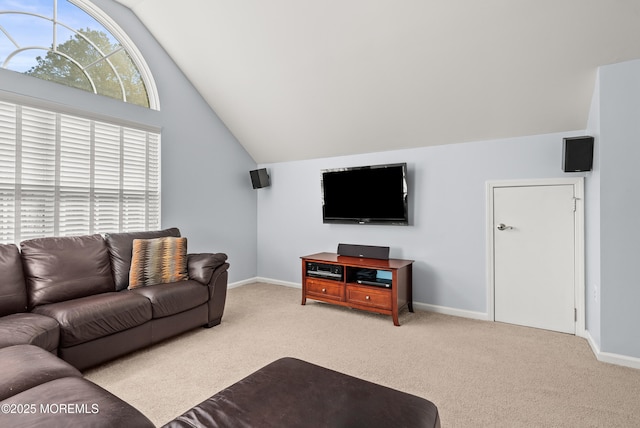 living room with lofted ceiling, carpet, and baseboards