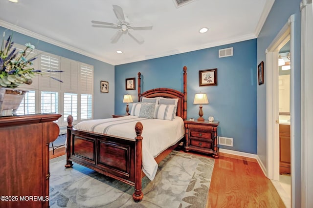 bedroom with baseboards, light wood-style flooring, visible vents, and crown molding