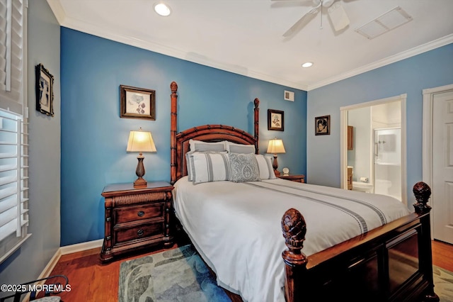 bedroom featuring visible vents, crown molding, baseboards, and wood finished floors