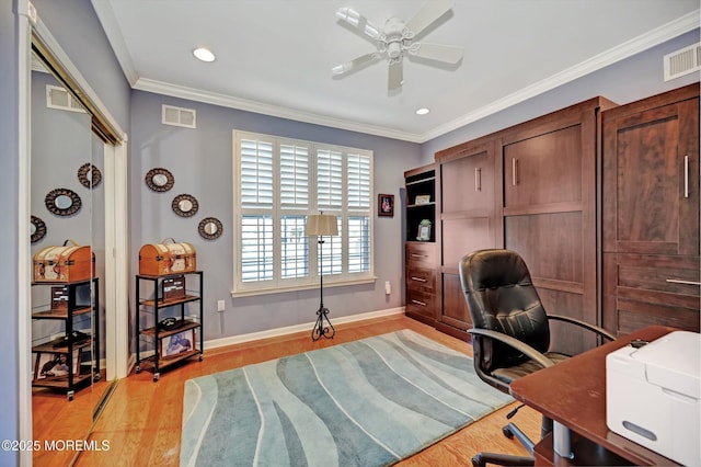 office space featuring light wood-style floors, a ceiling fan, visible vents, and crown molding