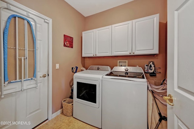 laundry room with washing machine and clothes dryer, cabinet space, and baseboards