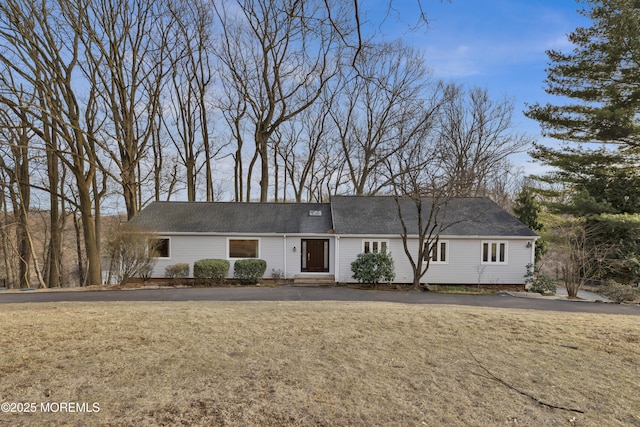 single story home with entry steps and a front lawn