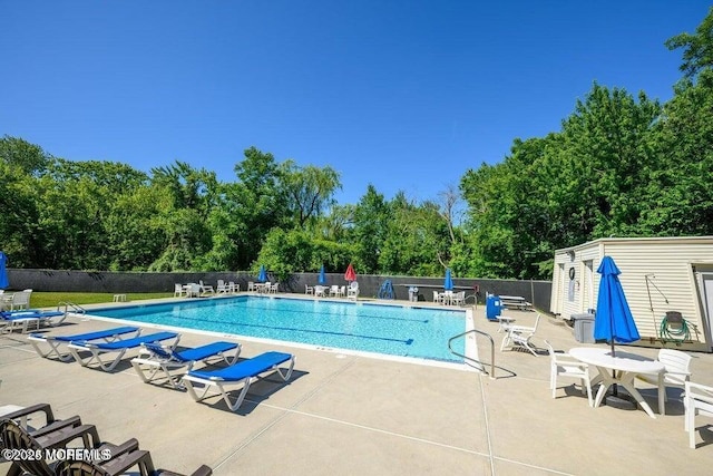 pool featuring a patio and fence