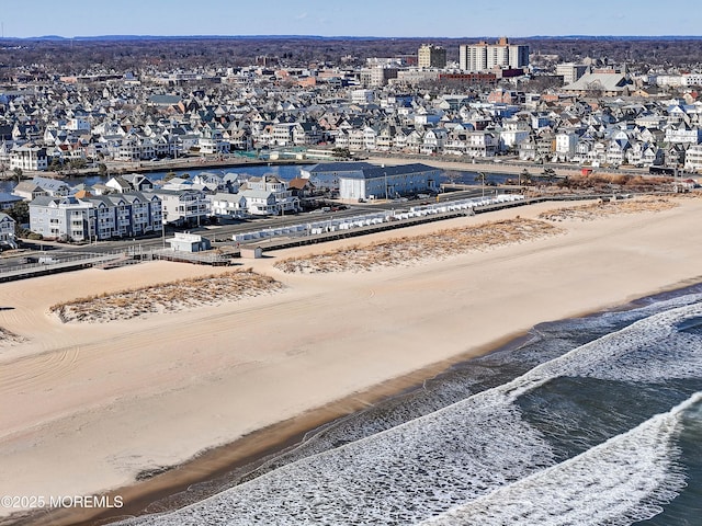 birds eye view of property featuring a view of the beach and a water view