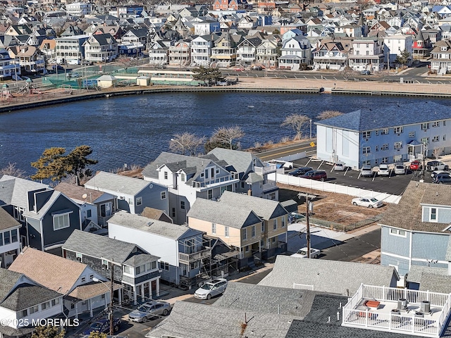 birds eye view of property with a residential view and a water view