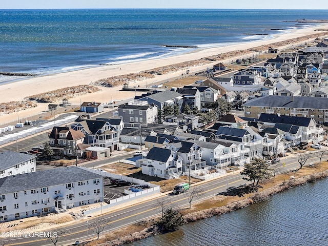 aerial view featuring a view of the beach and a water view