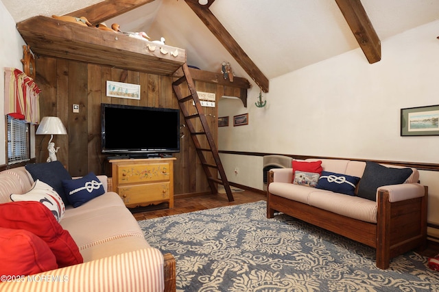 living room featuring baseboards, wood finished floors, and vaulted ceiling with beams