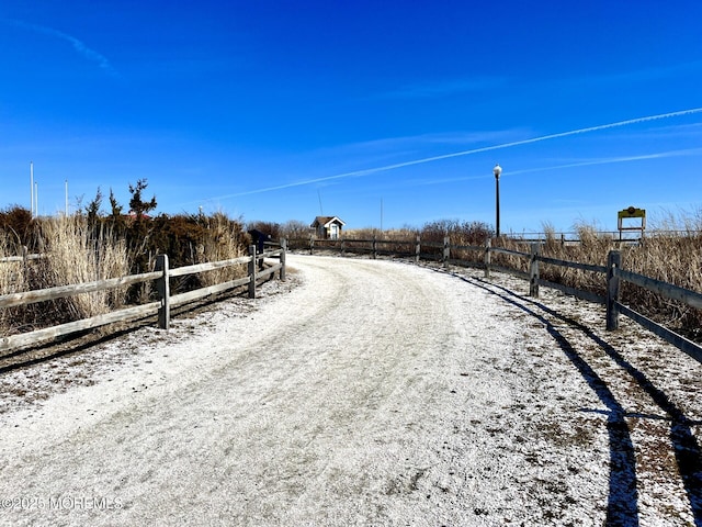 view of road with a rural view and driveway