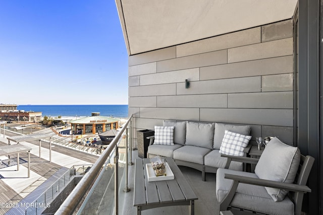 balcony featuring an outdoor hangout area and a water view