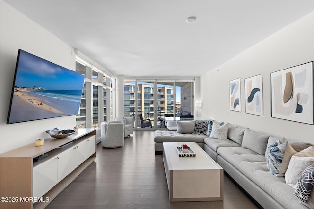 living area with a wall of windows and dark wood-style flooring