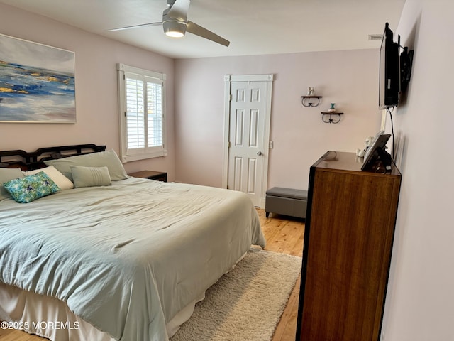 bedroom with light wood finished floors and a ceiling fan