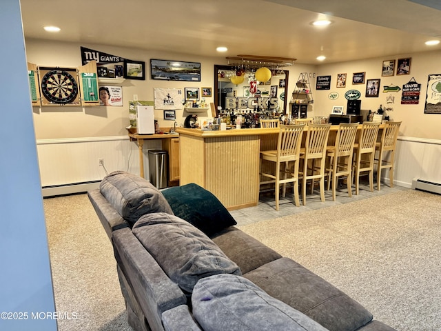 bar featuring a bar, a baseboard radiator, recessed lighting, and wainscoting