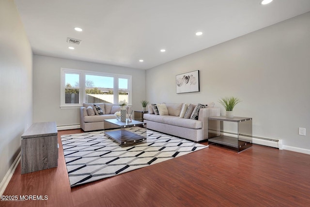 living area with a baseboard radiator, wood finished floors, visible vents, and recessed lighting