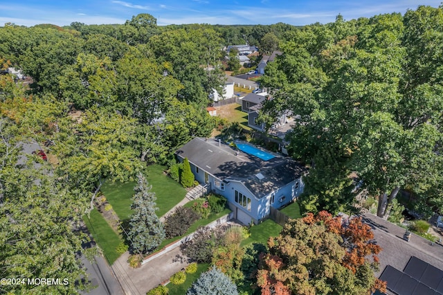 drone / aerial view featuring a forest view