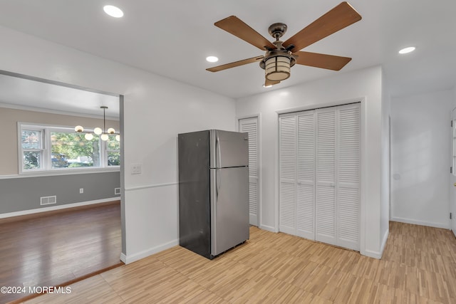 kitchen featuring baseboards, freestanding refrigerator, ceiling fan with notable chandelier, light wood-type flooring, and recessed lighting