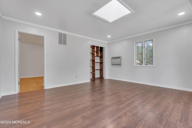 spare room featuring visible vents, dark wood finished floors, and ornamental molding