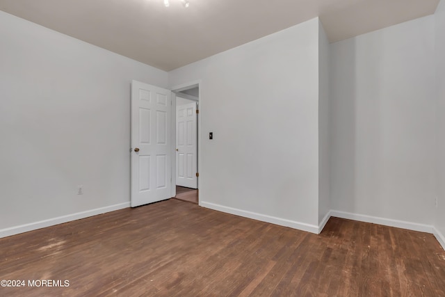 unfurnished room featuring baseboards and wood finished floors