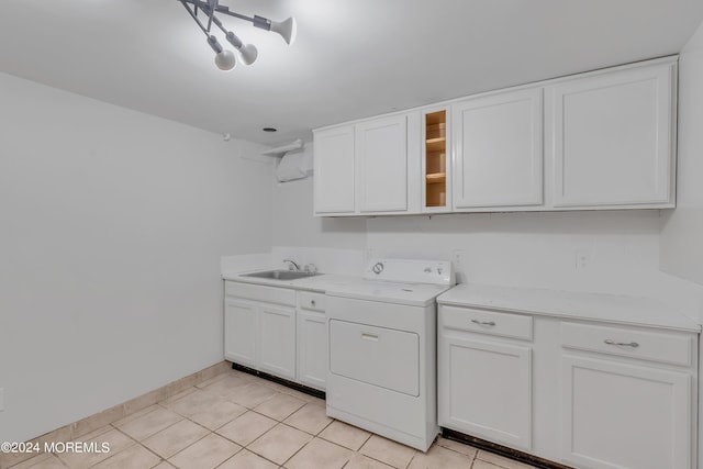 laundry area with washer / dryer, light tile patterned floors, cabinet space, baseboards, and a sink