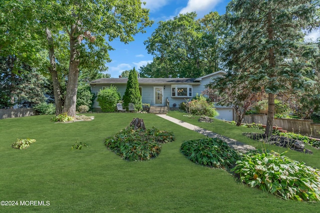 ranch-style home featuring a front yard and fence