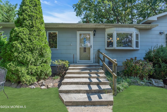 doorway to property featuring a yard