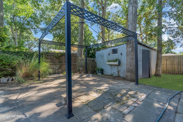 view of patio featuring a fenced backyard and an outdoor structure