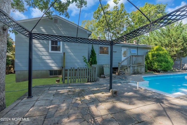 pool featuring a yard and a patio area