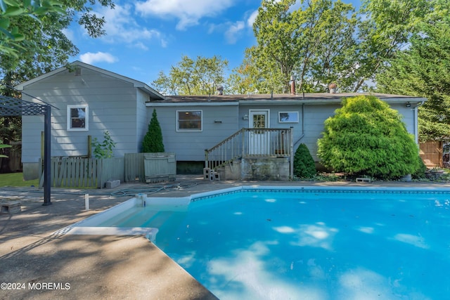 view of swimming pool with a fenced in pool, a patio, and fence