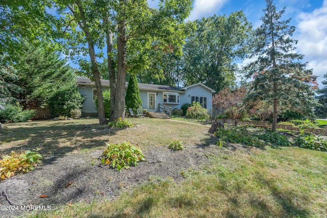 ranch-style home featuring a front yard and fence