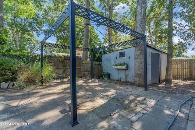 view of patio with an outbuilding and a fenced backyard