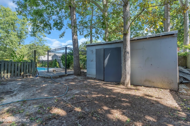 view of shed with fence