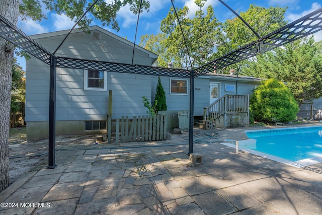 back of house with a patio area and an outdoor pool