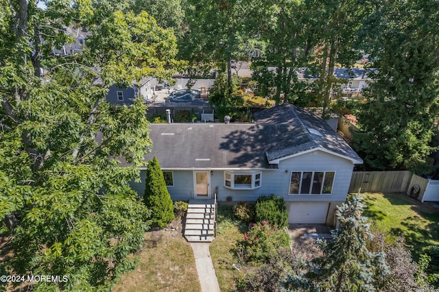 view of front of home with a garage and fence