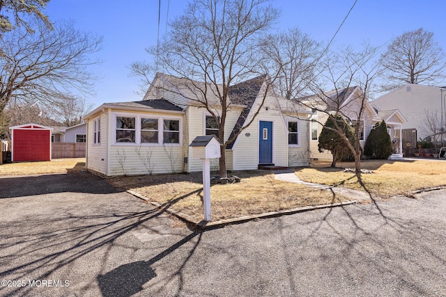 view of front of home with an outbuilding and fence