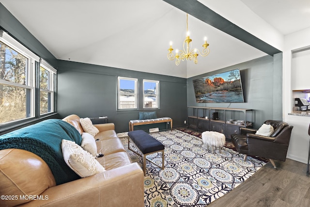 living room featuring an inviting chandelier, vaulted ceiling, and wood finished floors