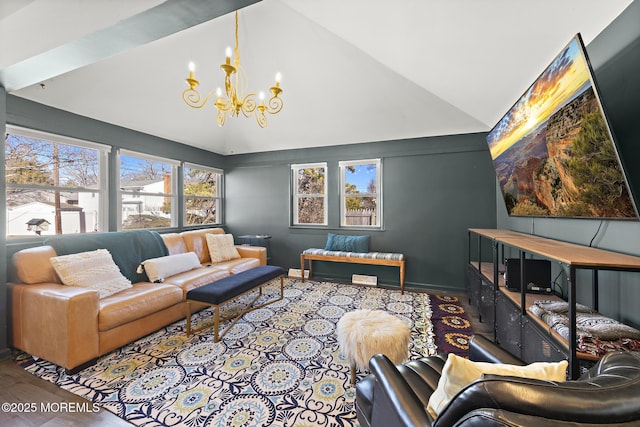 living area with baseboards, high vaulted ceiling, wood finished floors, and a notable chandelier