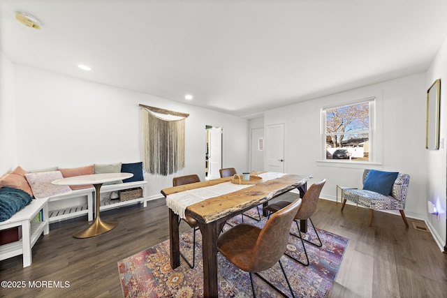 dining area with baseboards, wood finished floors, and recessed lighting