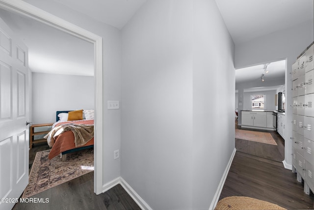 hallway with dark wood-style floors and baseboards