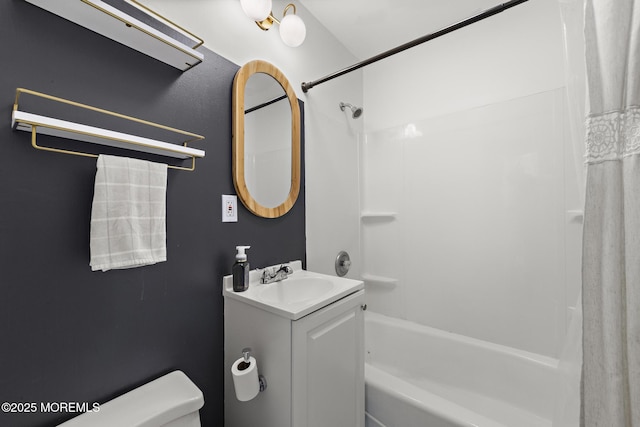 bathroom featuring toilet, shower / bath combo with shower curtain, and vanity