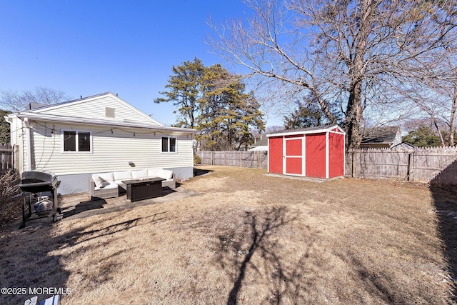 back of property featuring an outbuilding, a fenced backyard, and a storage shed