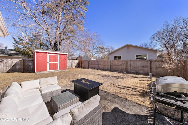 view of yard with an outbuilding, a fenced backyard, an outdoor living space, and a shed